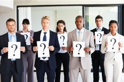 company marketing team with questions image includes marketing team holding up diagram of question marks